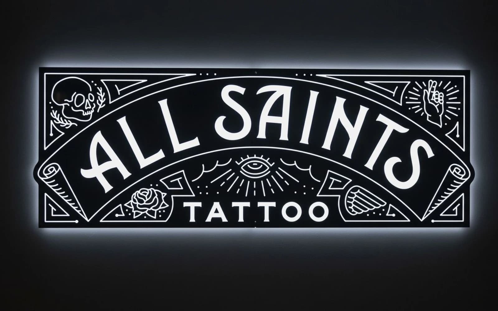 Backlit sign mockup for All Saints Tattoo & Body Piercing