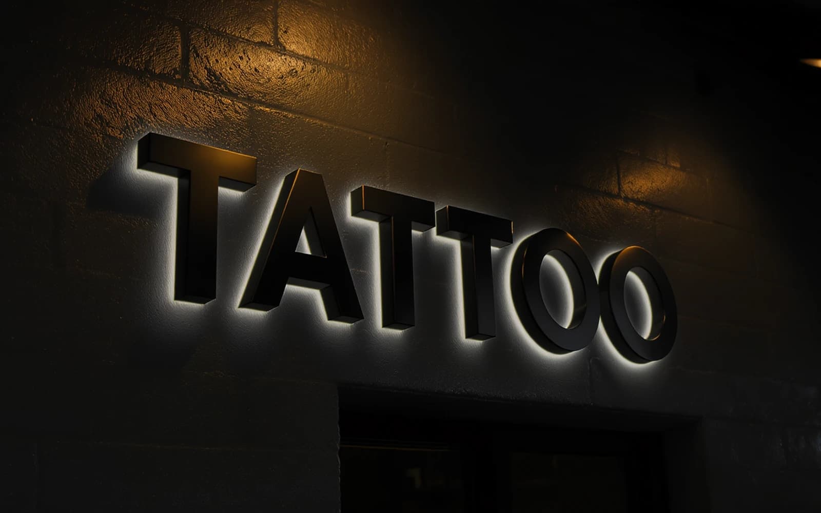 Backlit sign mockup for Hart & Huntington Tattoo Co.