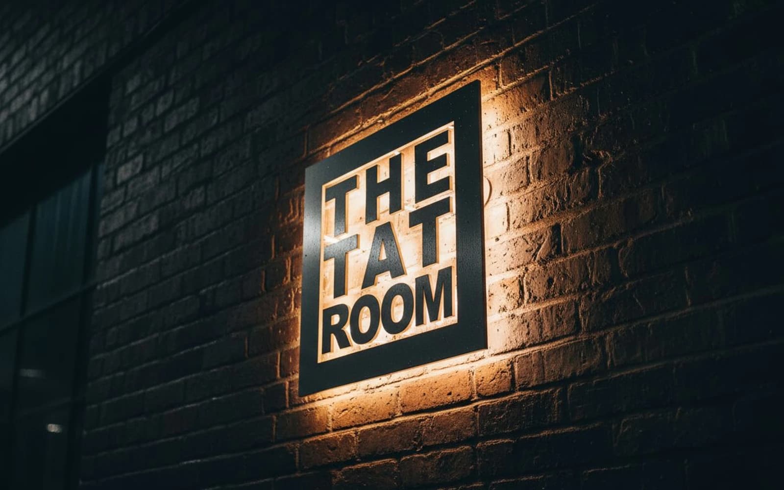 Backlit sign mockup for The Tat Room